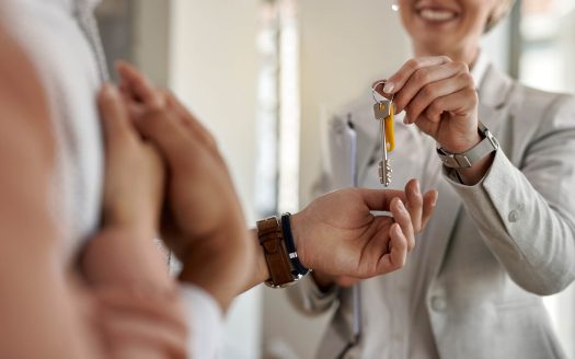 closeup couple receiving keys their new apartment from real estate agent